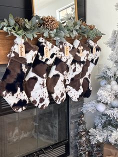 three christmas stockings hanging from a fireplace mantel