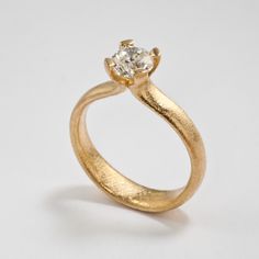 a gold ring with a diamond on it