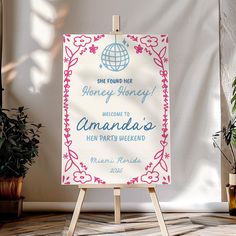 an easel with a sign that says welcome to amanda's new party weekend