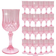 pink wine glasses are lined up on a shelf