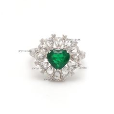 an emerald and diamond heart ring