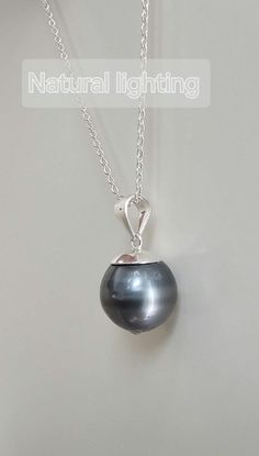 Free mini S925 name tag This platinum-gray Tahitian necklace is definitely a high-value choice. The pendant features a near-round Tahitian pearl with a diameter of 11.8-12mm. The surface  have some natural growth dots, but they are completely invisible from a normal social distance. The dark platinum-gray luster and tone also perfectly conceal any flaws. The main color of the pearl is a noble and elegant platinum gray, a highly sought-after color in Tahitian pearls, making it suitable for pairin Gray Pearl Drop Jewelry For Gift, White Gold Tahitian Pearl Necklace For Gift, Tahitian Pearl Round Pendant Necklace For Gift, Gray Round Jewelry For Gift, Gray Round Jewelry Gift, Gray Pearl Pendant Jewelry Gift, Gray Pearl Pendant Jewelry As Gift, Gray Pearl Pendant Jewelry For Gift, Elegant Gray Necklace Perfect For Gifts