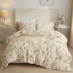 a bed with white sheets and yellow flowers on it