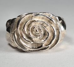 **Please note that we dispatch on Tuesdays unless special delivery express option is paid for** Sterling silver Camellia ring. Original design carved in wax then lost wax cast into solid sterling silver.  Piece weighs approximately 17g.  Shown in a size N, and adjustable to ring sizes I-S.  A significant size adjustment may alter the appearance slightly.  First class post included, with a supplement for special delivery. Hand Cast Silver Rings For Anniversary, Unique Silver Signet Ring For Anniversary, Anniversary Carved Sterling Silver Ring, Anniversary Sterling Silver Carved Rings, Carved Sterling Silver Rings For Anniversary, Sterling Silver Carved Promise Ring, Unique Hand Cast Sterling Silver Signet Ring, Silver Carved Signet Ring Gift, Silver Carved Engraved Ring For Anniversary