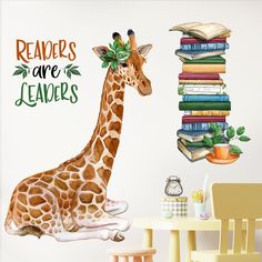 a giraffe sitting next to a stack of books