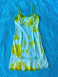 Expertly hand dyed nylon vintage slip dress. Layer this look over a turtle neck in the winter or over a swimsuit by the pool, they're great on their own too! This vintage slip has been carefully tie dyed to disguise stains and discoloration. Originally white, it has a unique all over tie dye pattern in lime green and teal. Can be washed on cold with like colors. This is a one of one item This slip is in very good vintage condition. There are no holes or tears. The straps are adjustable. Bust: 40" Waist: 34" Hips: 42" Length: 42" Fitted Green Dress For Poolside, Hand Dyed Fitted Summer Dress, Teal Tie, Vintage Slip Dress, Dress Layer, Vintage Slip, One Of One, Vintage Slips, Knee High Leather Boots