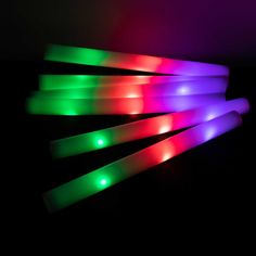 four glow sticks with different colored lights on them