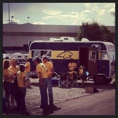 some people are standing in front of a trailer