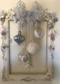 an ornate frame with ornaments hanging from it