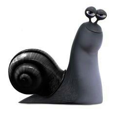 a black snail figurine sitting on top of a white surface