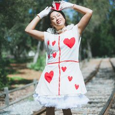 This is a listing for the Red Queen's Rabbit steward costume.  Costume Comes set:  Rabbit Ears Top HAT,  White and Red Heart Card TUNIC ,  white lace DRESS, White ruffle CHOKER.  This is an adult size costume that fit's up to a size 12 women's.  Costume does NOT include petticoat, or shoes. Queen Of Hearts And White Rabbit Costume, White Rabbit Costume Ideas, Plus Size White Rabbit Costume, Fitted Costume Hats And Headpieces For Cosplay, White Fitted Costume For Themed Events, Fitted White Costume Accessories For Cosplay, White Costume Hats And Headpieces For Carnival, White Ruffled Costume For Costume Party, Fitted White Costume With Ruffles