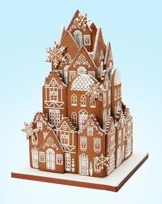 a gingerbread house with snowflakes on it's roof is shown in front of a white background