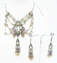 DESIGNER INSPIRED  16 in GREEN MULTI CRYSTAL  SILVER VICTORIAN  JEWELERY SET NEW Up for your consideration is a GREEN multi crystal unique filigree Victorian Chandelier Necklace and Earrings Jewelry Set. ALL SET IN SILVER TONE METAL  Necklace measures 12.5 in with a 3.5 in EXTENDER Silver figaro chain with lobster claw closure   center station measures 4  in by 3.5 in with crystal drops  French Wire Hook Pierced Chandelier Earrings measure 2 1/2 in by 1/2 in Great gift Idea. Please ask all questions prior to ordering! Green Crystal Rhinestone Necklace, Ornate Green Jewelry With Jewels, Green Crystal Jewelry With Rhinestones, Green Crystal Necklace With Jewels, Green Crystal Jewelry With Jeweled Details, Green Jeweled Crystal Rhinestone Necklace, Green Jeweled Rhinestone Crystal Necklace, Green Rhinestone Jeweled Necklace For Gift, Green Jeweled Rhinestone Necklace For Party