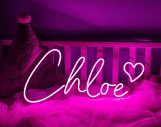 a neon sign that says,'i love you'in front of a crib