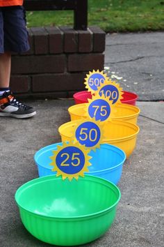 four buckets with numbers on them sitting in front of a brick wall