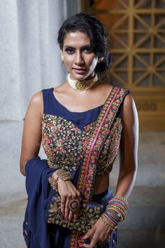 A cool, chic saree!!! This modern take on a saree is elegant and modern! Navy blue georgette pallu stitched to raw silk pants! the blouse is sleeveless with in built padding! The multicolor resham embroidery is highlighted with gold sequin for sparkle and shine! Traditional Sleeveless Chanderi Pre-draped Saree, Semi-stitched Sleeveless Pre-draped Saree With Cutdana, Semi-stitched Sleeveless Georgette Pre-draped Saree, Sleeveless Chanderi Pre-draped Saree For Festive Occasions, Reception Pre-draped Saree With Unstitched Blouse, Bollywood Style Sleeveless Pre-draped Saree For Reception, Sleeveless Georgette Traditional Wear For Navratri, Bollywood Style Sleeveless Pre-draped Saree For Diwali, Unstitched Sleeveless Blouse Piece With Resham Embroidery