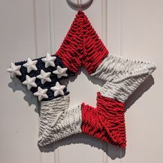 two red, white and blue stars are hanging on the front door ornament