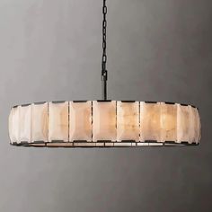 a chandelier hanging from a chain with marble blocks on it