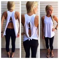 the back of a woman's white tank top and black leggings