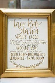 a gold framed sign that says taco bar station and the names of different restaurants