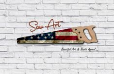 a brick wall with the word san art on it and a pair of scissors in front of an american flag