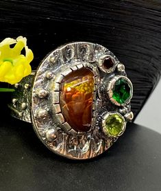 Mexican Fire Agate Gemstone ring in sterling silver size 10 1/4 Materials: Silver 925,  Mexican Fire Agate, Peridot, Lab Grown Emerald, Garnet Face of the ring:  Height-25mm, Width-25mm, Band-12-8mm Unique Handcrafted One-of a-kind Design Ring Each Piece of Jewelry in my Collection is Absolutely One of a Kind! When you start wearing a piece of my jewelry you will fall in love with it more and more each day and feel that good Energy and Love that I pass into it while creating this piece of Art. A Artisan Amber Gemstone Rings, Artisan Amber Ring Jewelry, Unique Collectible Rings With Natural Stones, Unique Opal Ring With Natural Stones For Anniversary, Unique Carnelian Ring Jewelry, Artisan Silver Opal Ring With Multi-stone, Unique Silver Opal Ring With Multi-stone, Unique Sterling Silver Opal Ring With Natural Stones, Unique Carnelian Ring For Anniversary