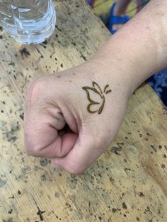 a person with a small tattoo on their hand