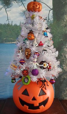 a white christmas tree decorated with halloween decorations