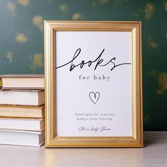 a framed book is sitting on a table next to books that are stacked up in front of it