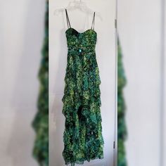 a green dress hanging on a white wall