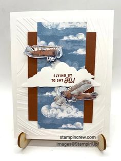 a card with an airplane and clouds on it