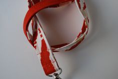 "Red and white lanyard. This listing is for ONE lanyard! Handmade by me with 100% cotton fabric measuring approximately 40-42 inches around(20\"-21\" Drop when placed around neck) and 3/4 inch wide. A key ring and a swivel clasp/hook are attached to the lanyard. Lanyards can be used for functional purposes such as I.D. wearing and attaching to keys for easy around-the-neck-wearing. This one would make an awesome gift. Hand washing recommended for lanyard, lay flat to dry. Thank You for shopping! Red Lanyards With Key Leash, Adjustable Red Lanyard With Key Leash, Adjustable White Lanyard With Key Leash, White Adjustable Lanyard With Key Leash, Adjustable Red Lanyard As Gift, Adjustable White Lanyard, Red Lanyards With Key Leash For Gifts, Red Lanyard With Key Leash As Gift, Keychain Lanyard