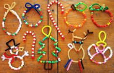 several bracelets made out of beads on a wooden table with an animal pinata attached to them