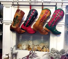 christmas stockings hanging from hooks in front of a fireplace