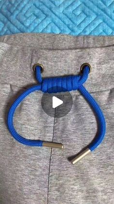 a close up of a person's pants with a blue rope on the side