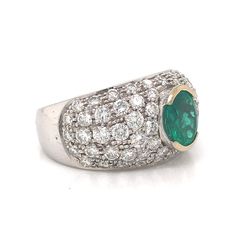 This glittering cocktail ring features a 1.05 carat emerald and diamonds. The center emerald features a medium sea green hue. A pave of thirty-two (32) .04 carat diamonds and thirty-two (32) .02 carat diamonds elegantly surround the center stone. The 18k white gold band adds a thoughtful radiance to this one of a kind cocktail ring. Disco elegance! A diamond ring with maximum sparkle. Finished in two-tone 18 karat white and 18 karat yellow gold. Diamond Cocktail Ring, Diamond Cocktail Rings, White Gold Band, Shop Engagement Rings, Sea Green, Gold Band, Cocktail Ring, Cocktail Rings, Pave Diamonds