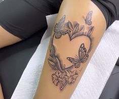 a woman laying down with a tattoo on her leg