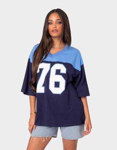 The Perfect Combination Of Comfy And Cool, This Oversized V-Neck Tee Will Have You Looking Sporty And Chic Wherever You Go. T-Shirt. Oversized Fit. Graphic Text. V-Neck. 100% Cotton. Model Wears Size S. Model Height Is 5'7. Item Care: Wash With Similar Color. | Edikted 76 Oversized Tee Football Girl, Oversized Jersey, Jersey Outfit, Streetwear Aesthetic, T Shirt Oversized, Basic T Shirt, Oversized T Shirt, Football Jersey, Oversized Tee