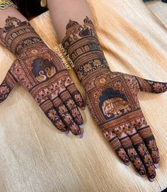 two hands with henna designs on them