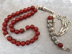 ✔️ This customized rosary made of 8 mm Carnelian Agate beads. ✔️ This top quality memorial rosary is a very special gift for your loved ones. ✔️ Each order comes in a special free gift box. ✔️ PLEASE CLICK THE LINK FOR ALL PRAYER BEADS MODELS https://www.etsy.com/shop/GoodJewelsofYazmasal Note: As a natural feature the stones beads may have some variations. SHIPPING: United States (Standart/DHL eCommerce/usps): 7-10 business days United States (Express/FedEx): 3-5 business days Canada (Express/F Round Polished Bead Rosary As Gift, Polished Round Beads Rosary As Gift, Silver Beads Rosary As Gift, Gift Rosary With Silver Round Beads, Spiritual Silver Beads Rosary Gift, Silver Beaded Rosary As Gift, Red Carnelian Beads For Gift, Red Carnelian Beads For Gifts, Handmade Red Rosary For Jewelry Making