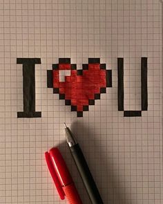 a red pen sitting on top of a piece of paper that says i love you