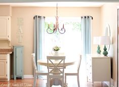 a dining room table and chairs in front of a window