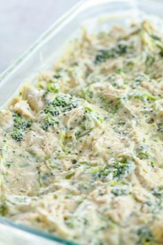 a casserole dish with chicken and broccoli in it on a table