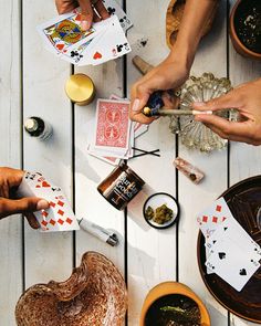 people are playing cards on a table