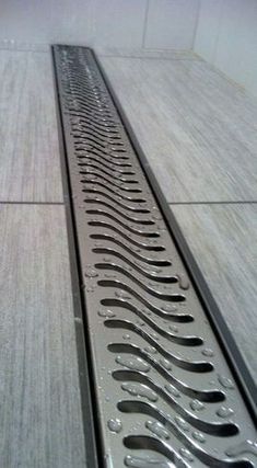 a metal grate sitting on top of a tiled floor