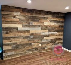 an empty room with wood planks on the wall and hard wood flooring in it