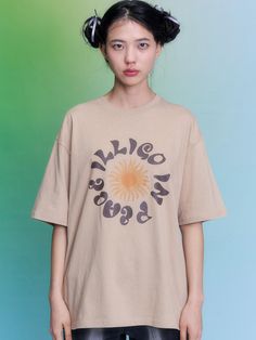 This product is an Ethnic Oversized T-shirt that features a distinctive sun and script graphic, which lends it a unique cultural flair. The oversized cut ensures a relaxed and comfortable fit, perfect for casual outings or lounging at home. Made from a breathable, soft fabric, this T-shirt combines style with comfort and is versatile enough to pair with a variety of bottoms. - The sun and script graphic adds an ethnic touch to the T-shirt, making it a standout piece in any wardrobe.- Its oversized fit provides maximum comfort and a modern, laid-back look.- Crafted from a soft and breathable fabric, the T-shirt is ideal for all-day wear, especially in warmer weather.- The neutral color palette allows for easy styling with diverse colors and accessories. Bohemian Short Sleeve T-shirt For Streetwear, Hippie Style Summer Streetwear T-shirt, Summer Hippie Streetwear T-shirt, Oversized Multicolor Graphic Print T-shirt, Oversized Multicolor Cotton T-shirt, Oversized Khaki Cotton T-shirt, Oversized Beige Cotton T-shirt, Oversized Organic Cotton T-shirt For Streetwear, Shirt Making