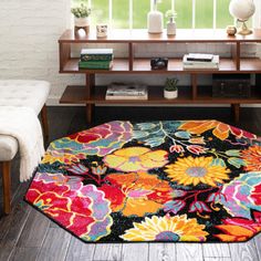 an area rug with flowers on it in front of a window