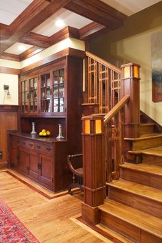 a wooden staircase leading up to a living room