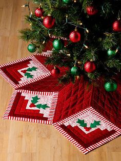 two red and white quilted christmas tree mats